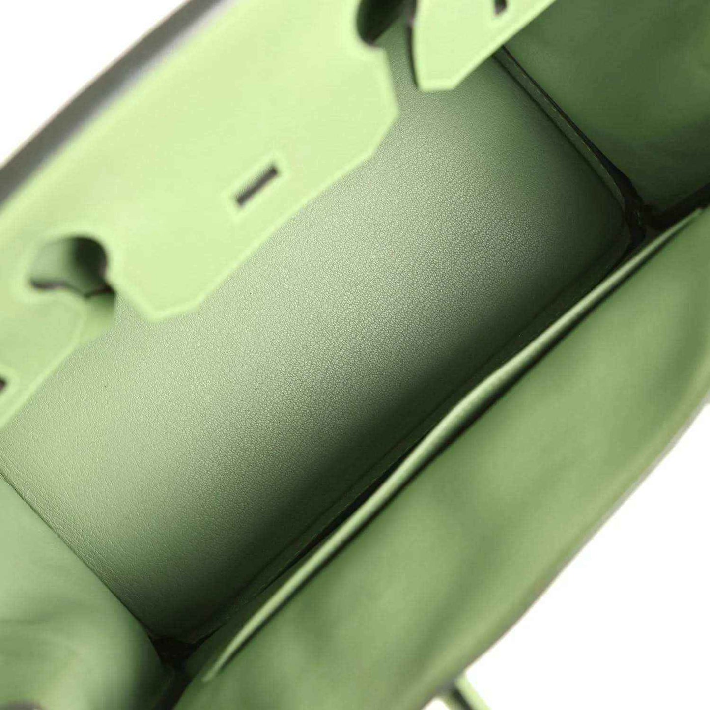 Interior of elegant green leather handbag with refined, timeless craftsmanship.