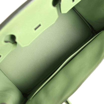 Interior of elegant green leather handbag with refined, timeless craftsmanship.