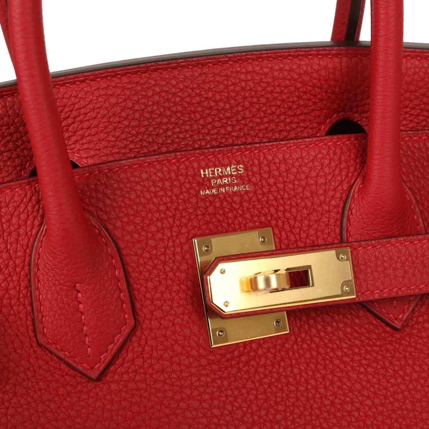 Elegant red leather handbag with gold hardware and timeless, sophisticated design