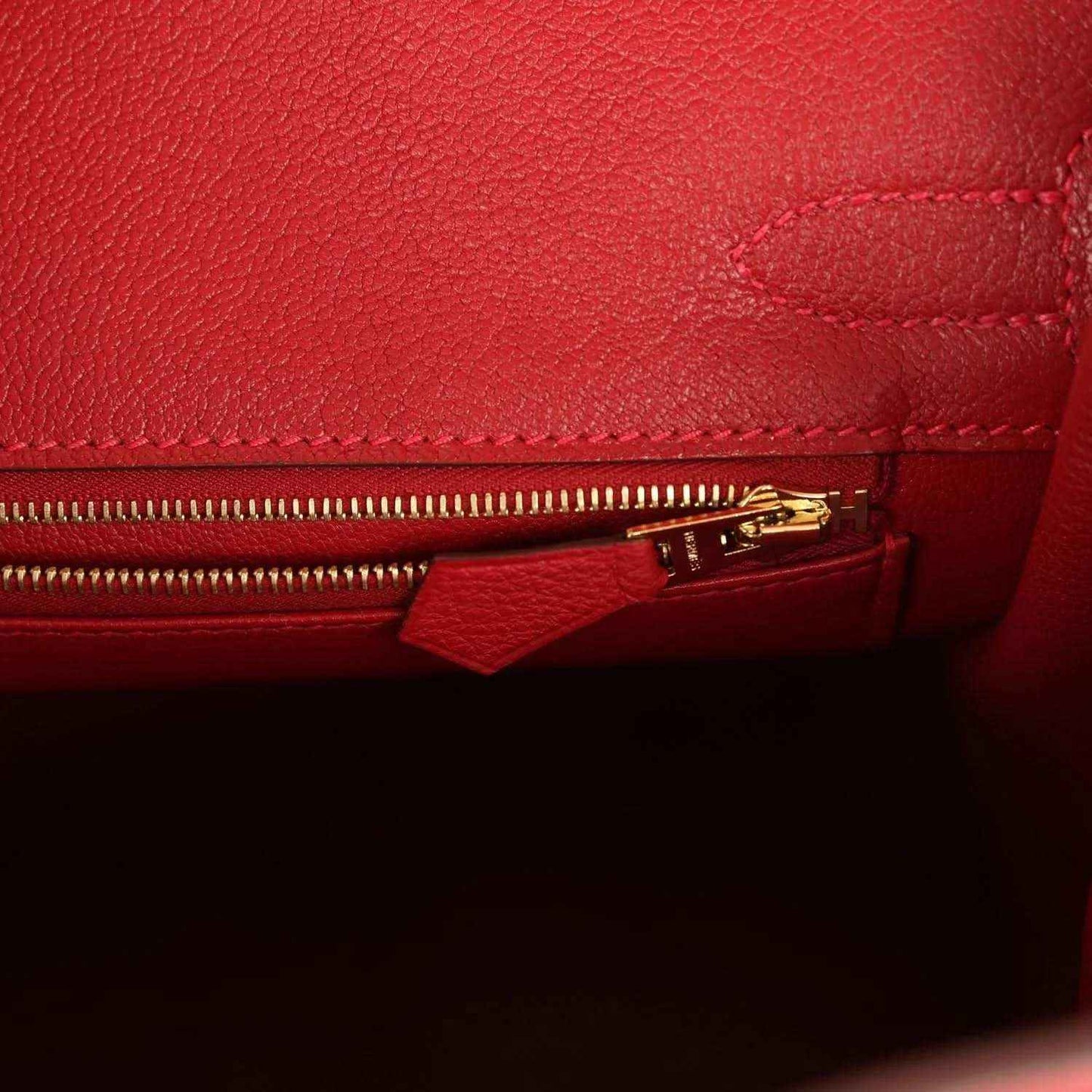 Timeless red leather handbag interior with elegant gold zipper detail