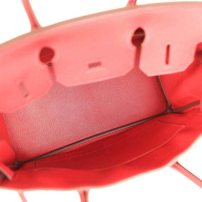 Elegant red leather handbag interior with timeless, sophisticated detailing