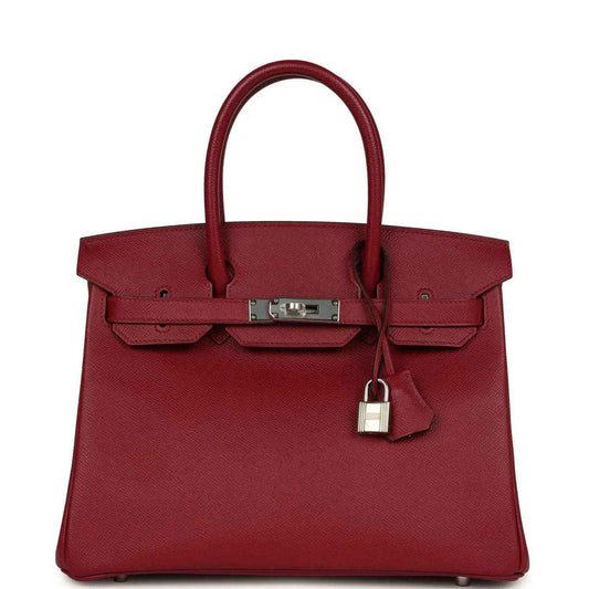 Elegant red leather handbag with silver hardware and a timeless, sophisticated design