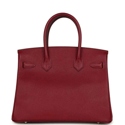 Elegant burgundy leather handbag with a timeless, sophisticated silhouette