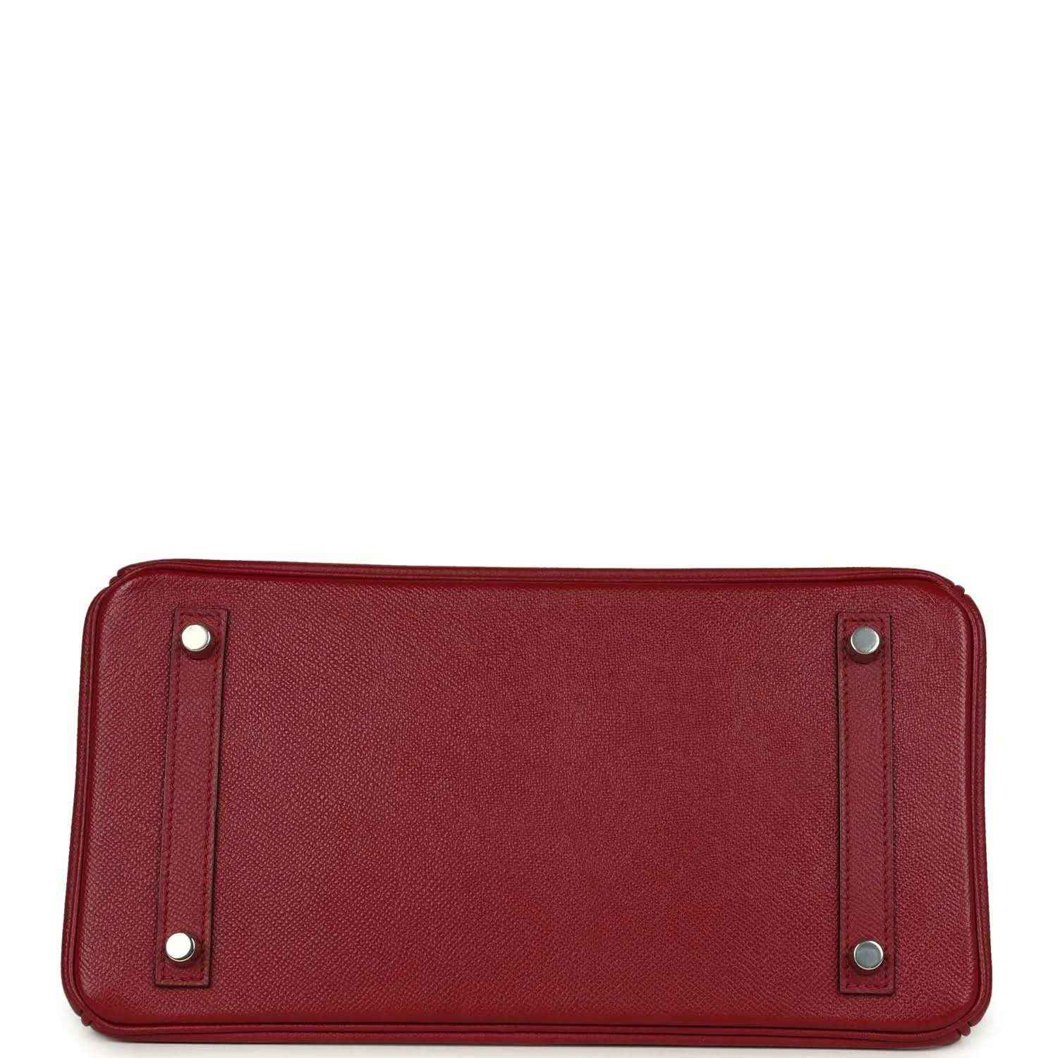 Bottom view of a timeless, elegant red leather handbag with silver feet and refined texture