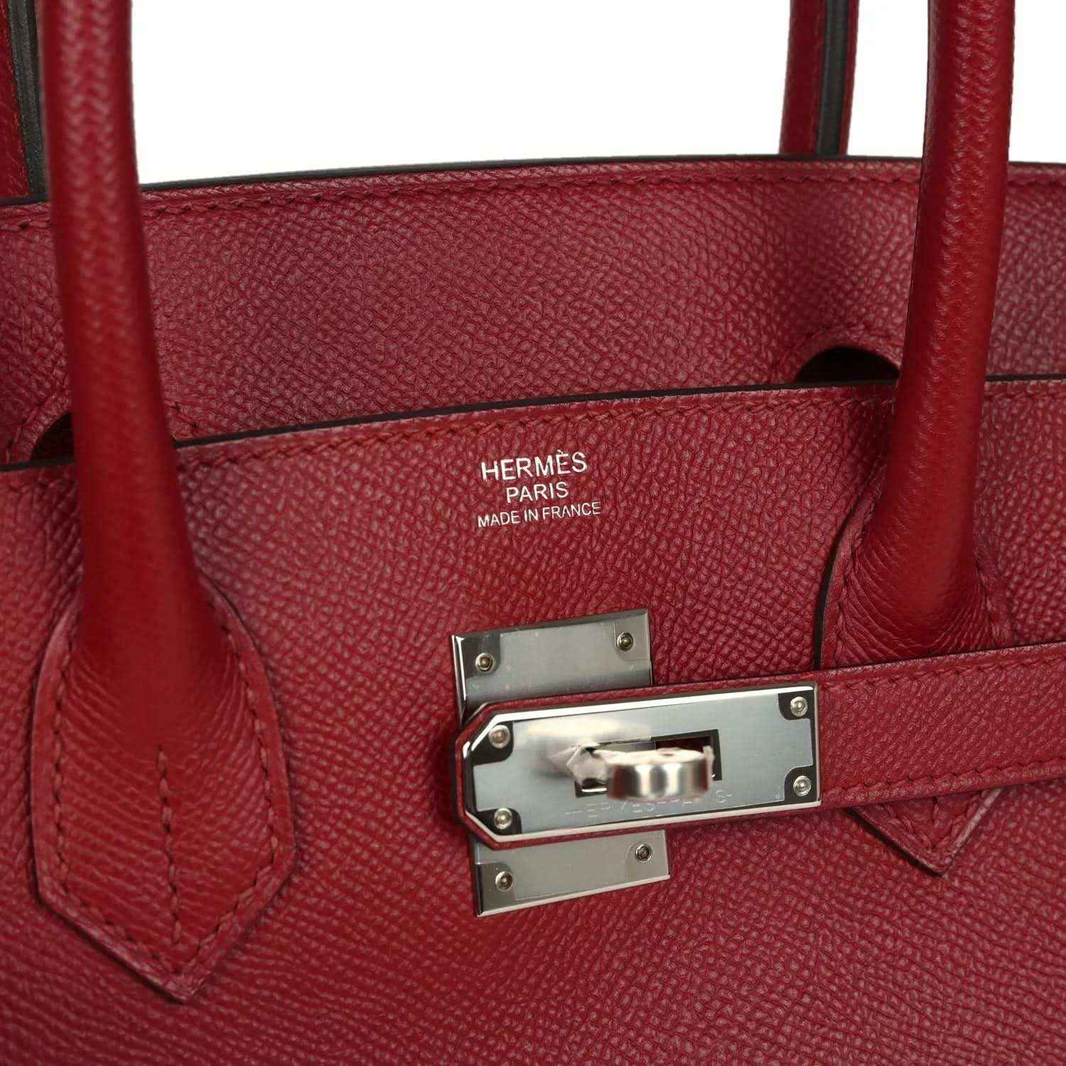 Elegant red leather handbag with silver hardware and sophisticated textured finish