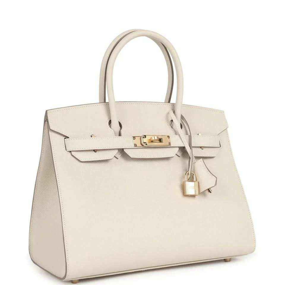 Elegant cream leather handbag with gold hardware, timeless and sophisticated design