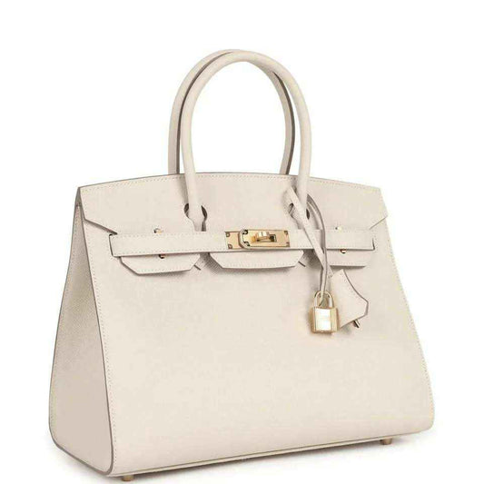Elegant cream leather handbag with gold hardware, timeless and sophisticated design