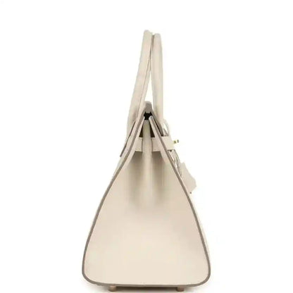 Elegant beige leather handbag with a structured, timeless silhouette and refined details