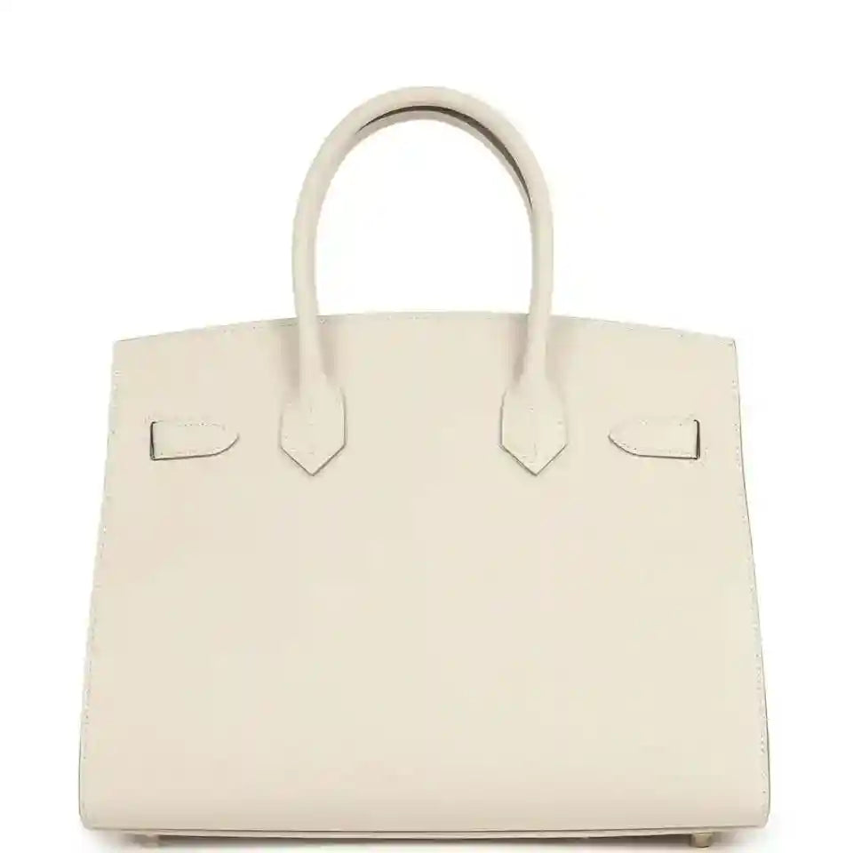 Timeless cream leather handbag with elegant top handles and sophisticated structured silhouette.