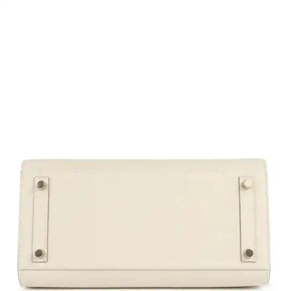 Timeless, elegant beige leather handbag base with gold-tone metal feet and refined stitching.