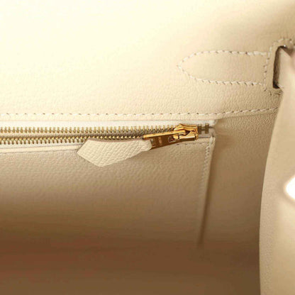 Elegant cream leather handbag interior with gold zipper and refined stitching