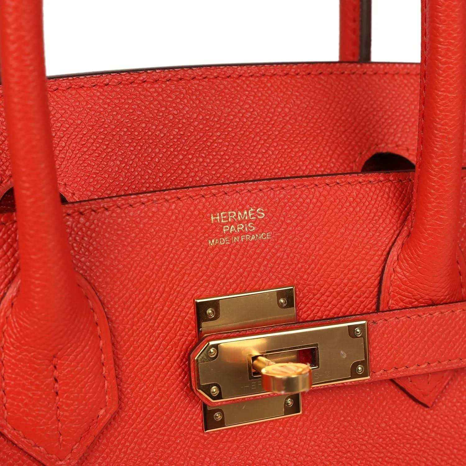Timeless red leather handbag with gold hardware and elegant textured finish.