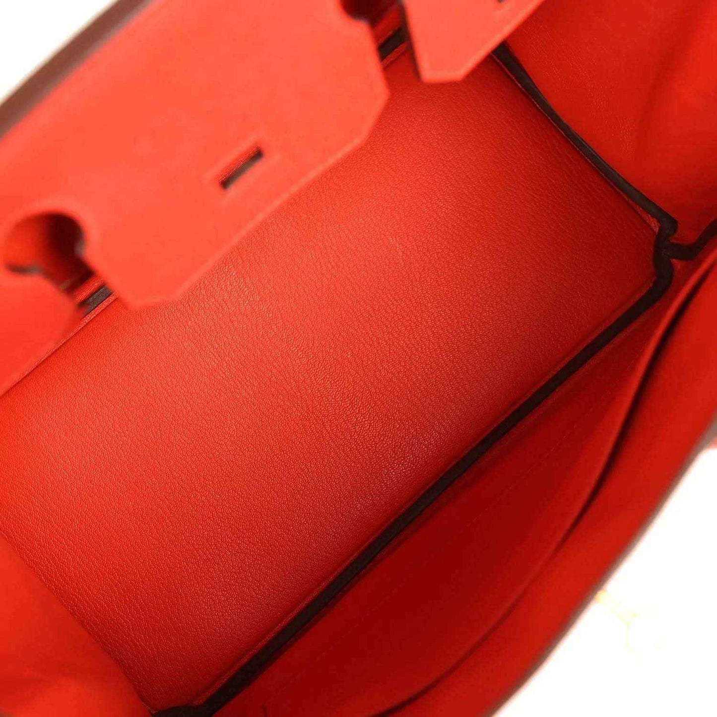 Elegant red leather handbag interior with refined, timeless craftsmanship and sophisticated finish.