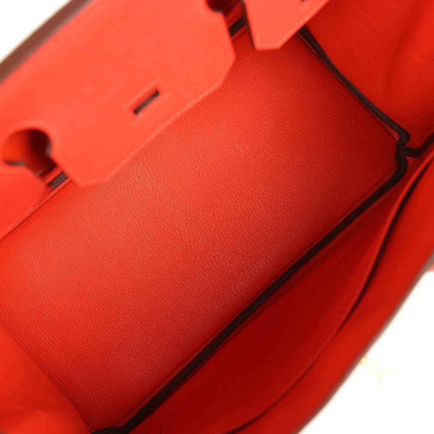 Elegant red leather handbag interior with refined, timeless craftsmanship and sophisticated finish.