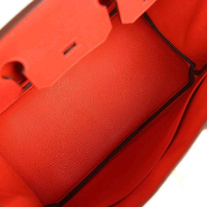 Elegant red leather handbag interior with refined, timeless craftsmanship and sophisticated finish.