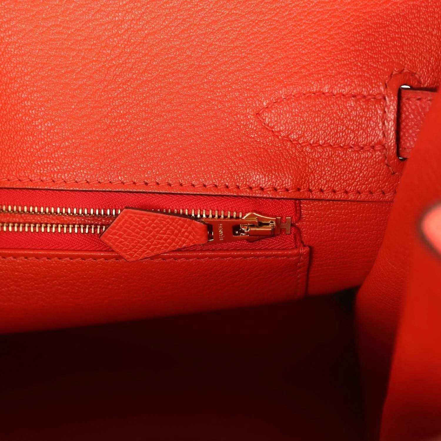 Elegant red leather handbag interior with gold zipper and refined stitching