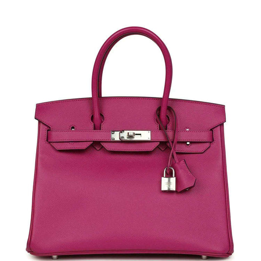Elegant magenta leather handbag with silver hardware and timeless, sophisticated design.