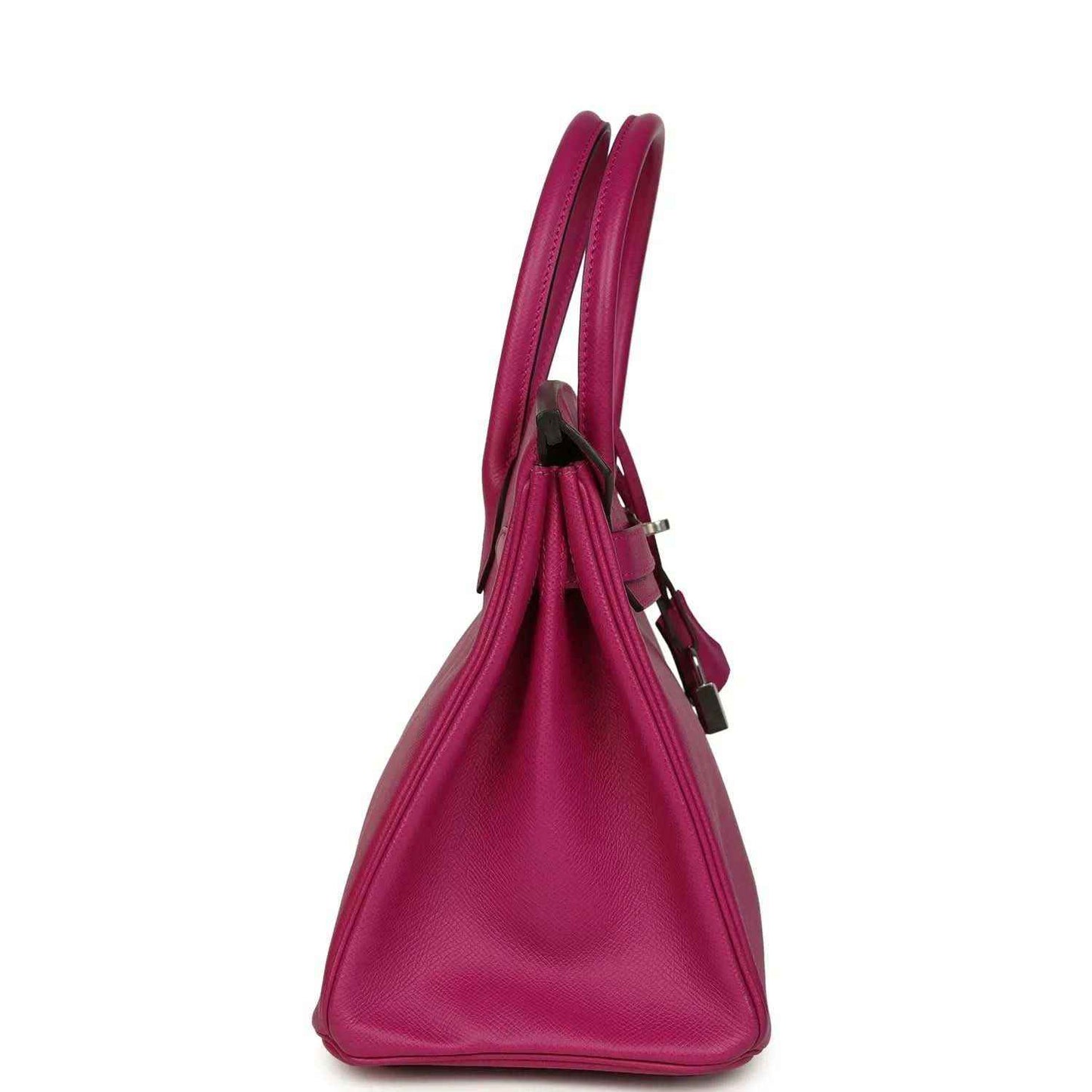 Elegant magenta leather handbag with structured silhouette and double handles, side view.