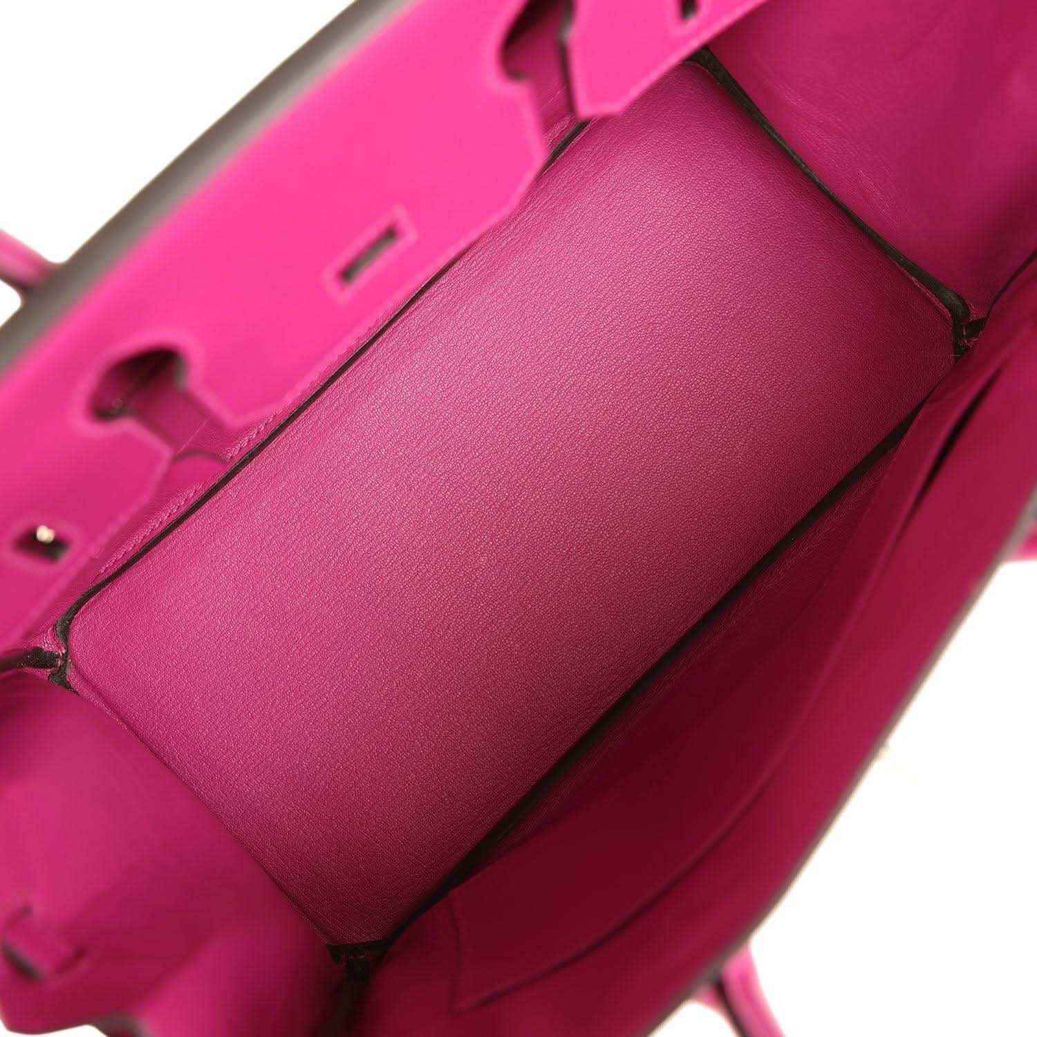 Interior of a sophisticated pink leather handbag with elegant, timeless design.