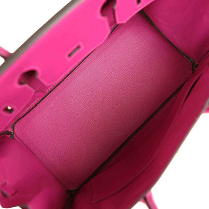 Interior of a sophisticated pink leather handbag with elegant, timeless design.