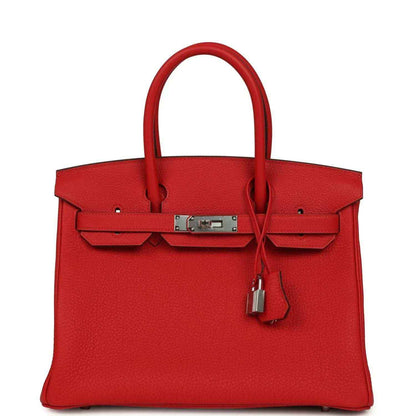 Timeless red leather handbag with silver hardware and elegant, structured design.