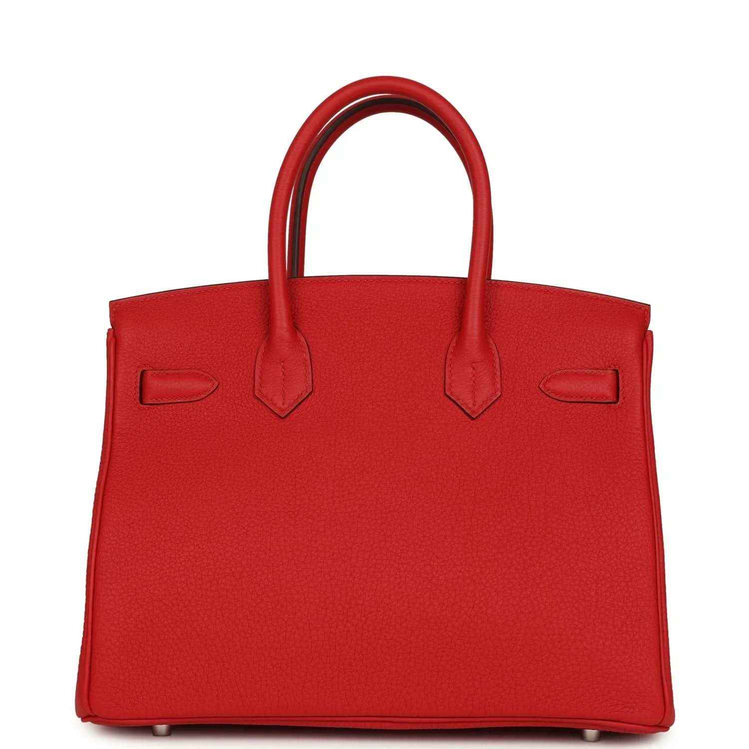 Elegant red leather handbag with structured silhouette and timeless, sophisticated design.