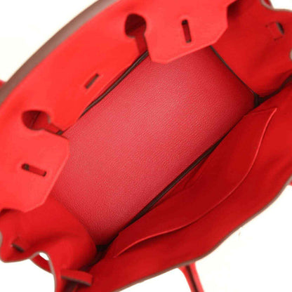 Elegant red leather handbag interior with refined stitching and spacious pocket design