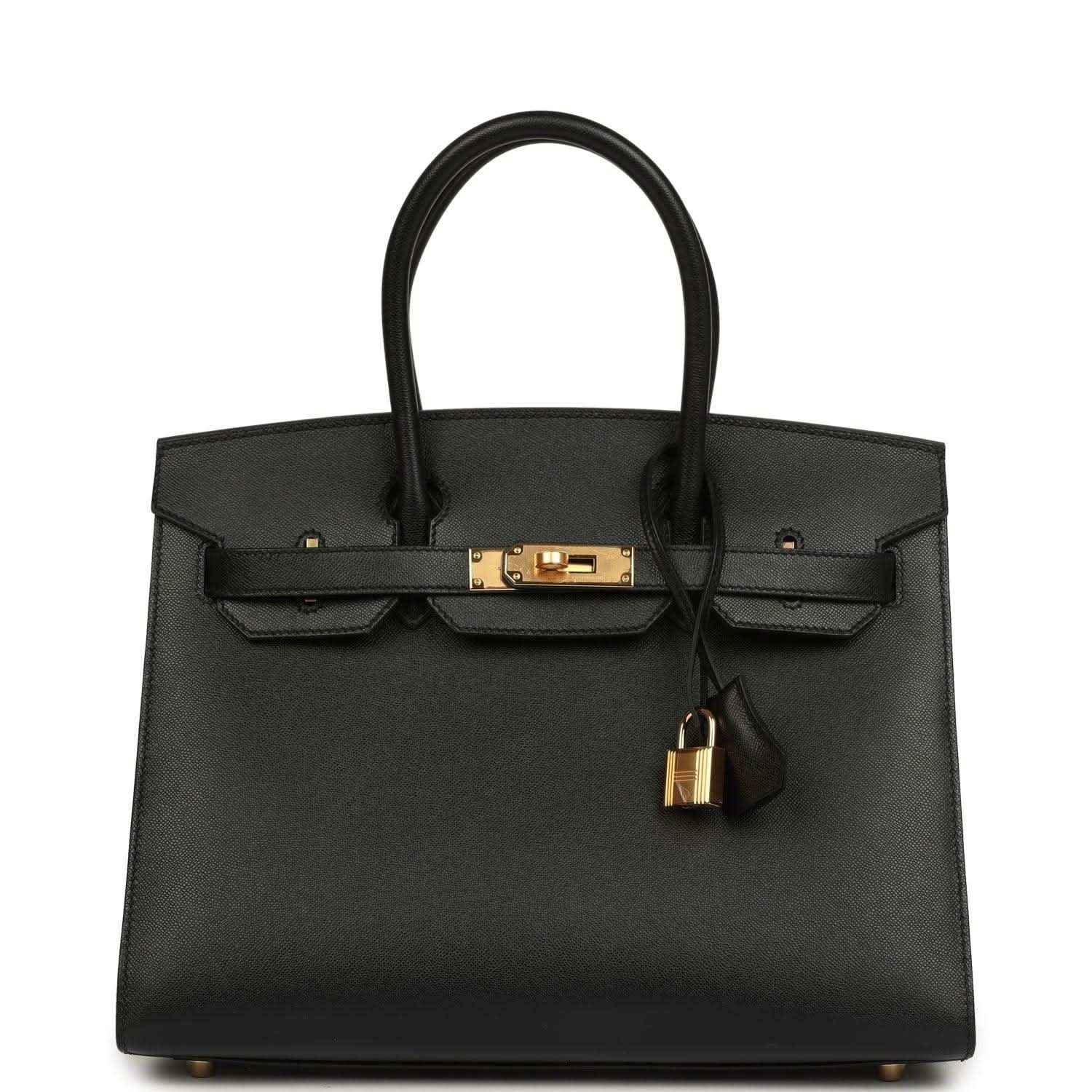 Elegant black leather handbag with gold hardware and a timeless, sophisticated design