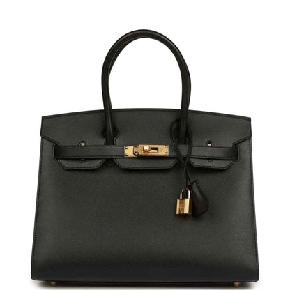 Elegant black leather handbag with gold hardware and a timeless, sophisticated design