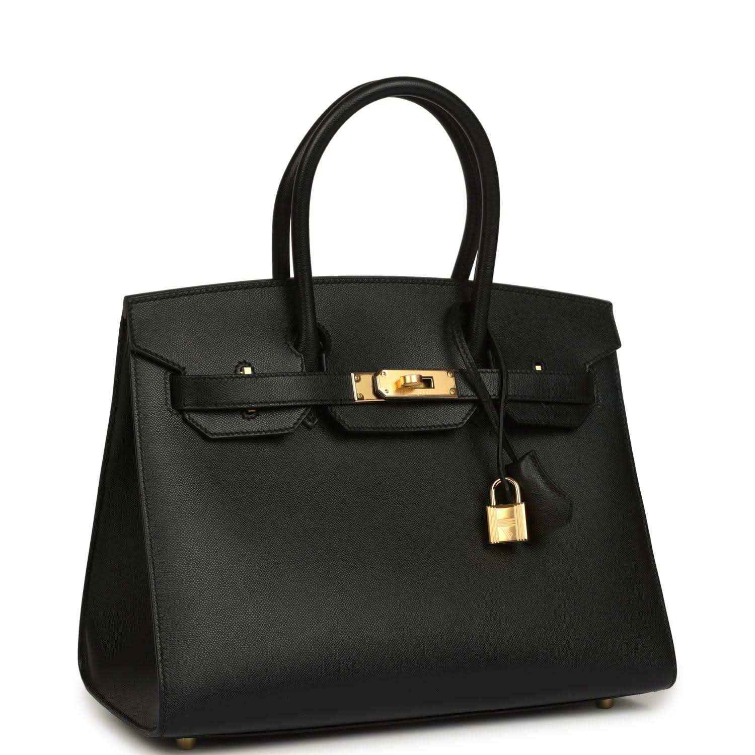 Elegant black leather handbag with gold hardware, timeless and sophisticated style.