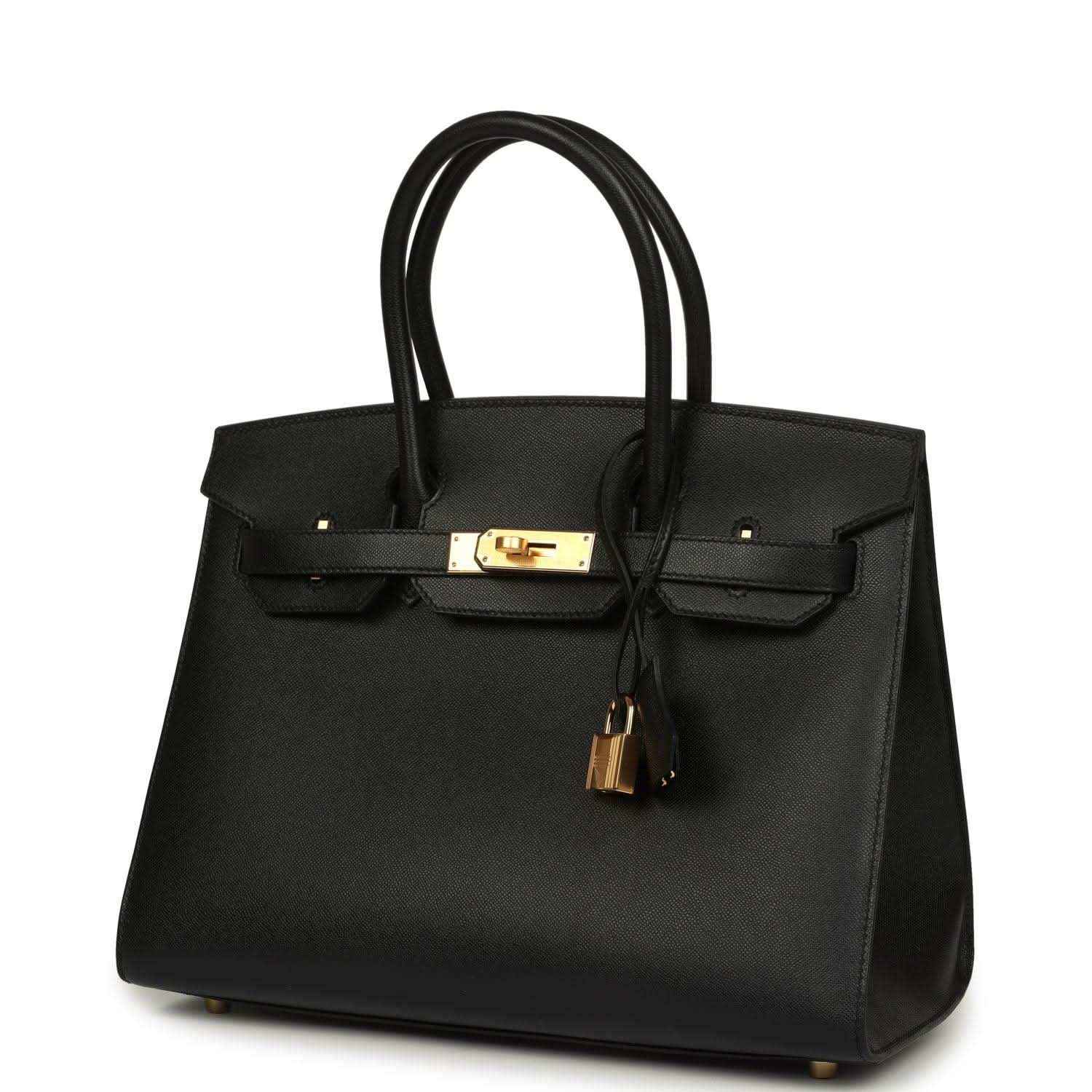 Elegant black leather handbag with gold hardware, sophisticated and timeless design