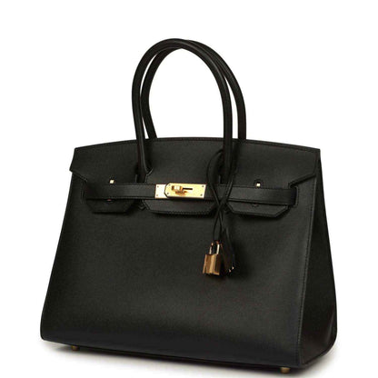 Elegant black leather handbag with gold hardware, sophisticated and timeless design