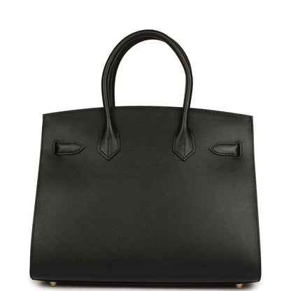 Timeless black leather handbag with elegant structured silhouette and refined handles.