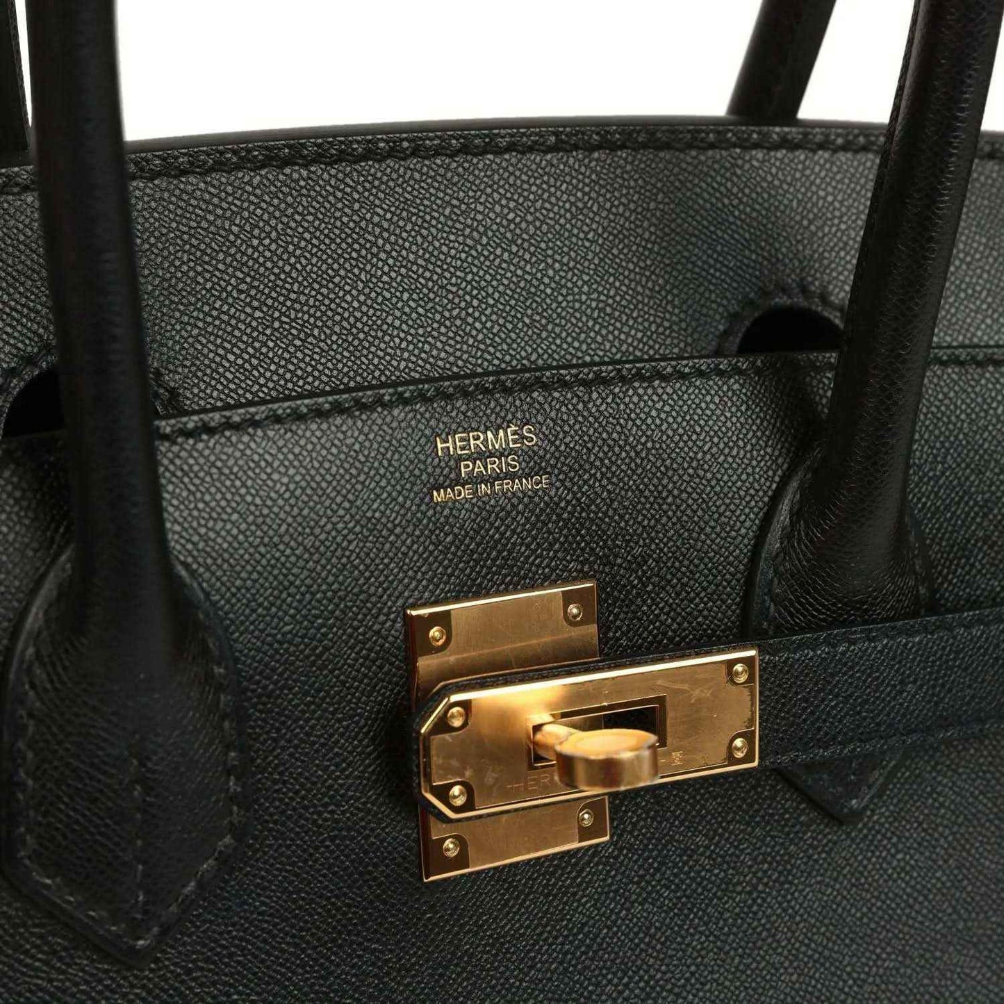 Elegant black leather handbag with gold hardware and sophisticated detailing