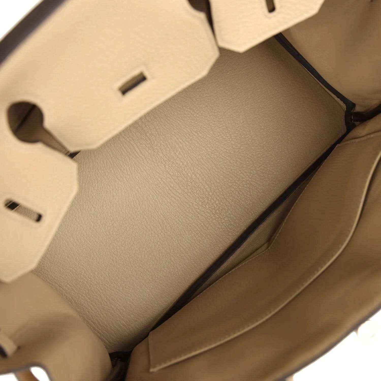 Interior view of a timeless beige leather handbag with elegant, sophisticated lining.