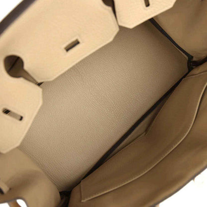 Interior view of a timeless beige leather handbag with elegant, sophisticated lining.