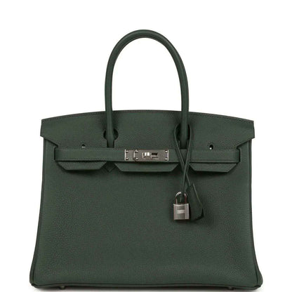 Timeless dark green leather handbag with silver hardware and elegant structured design