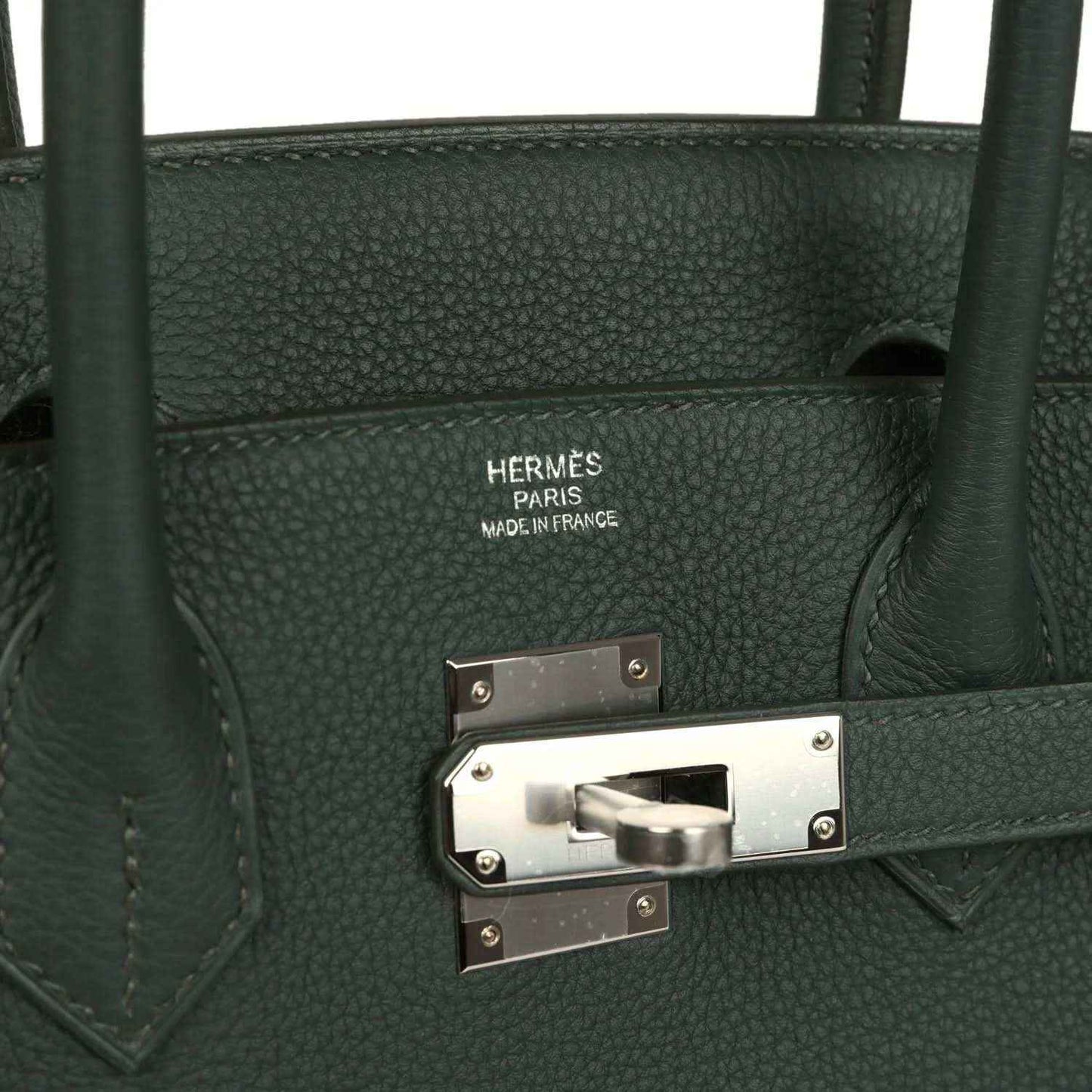 Timeless dark green leather handbag with elegant silver hardware and refined grain texture.