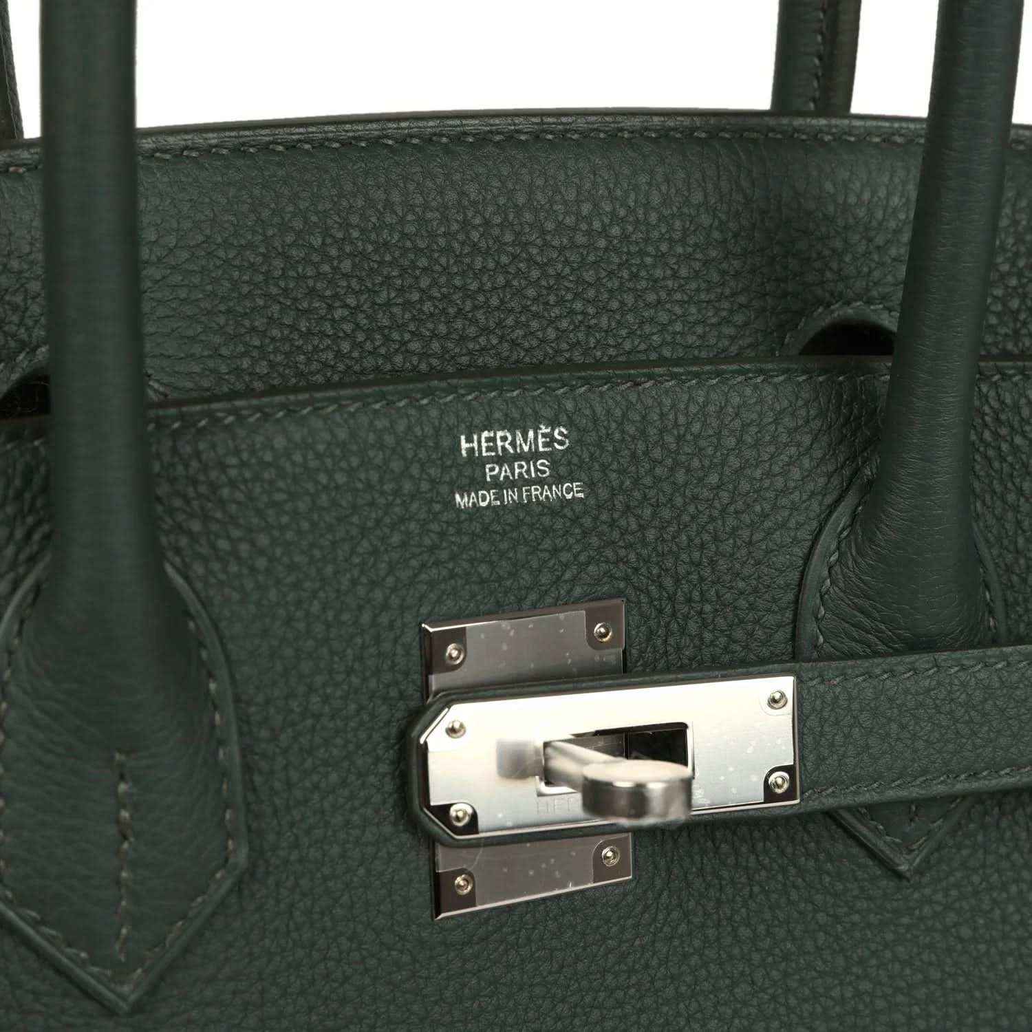 Timeless dark green leather handbag with elegant silver hardware and refined grain texture.