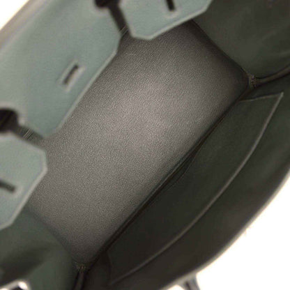 Spacious interior of a timeless, elegant black leather handbag with refined lining.