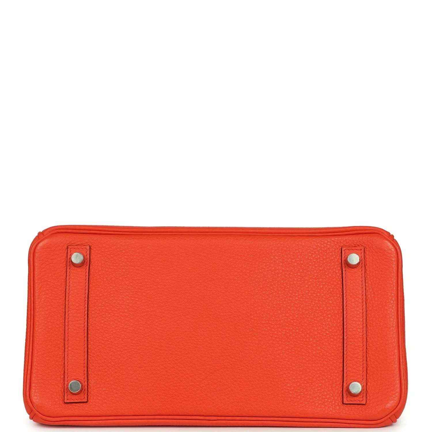 Elegant orange leather handbag base with silver-tone feet, showcasing timeless craftsmanship.