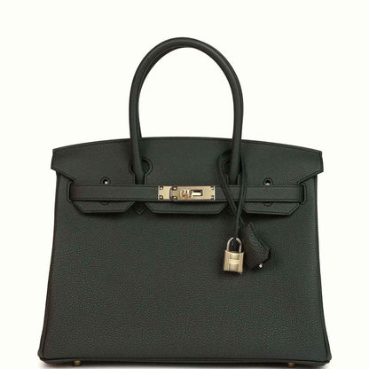 Elegant black leather tote handbag with gold hardware and timeless, sophisticated design