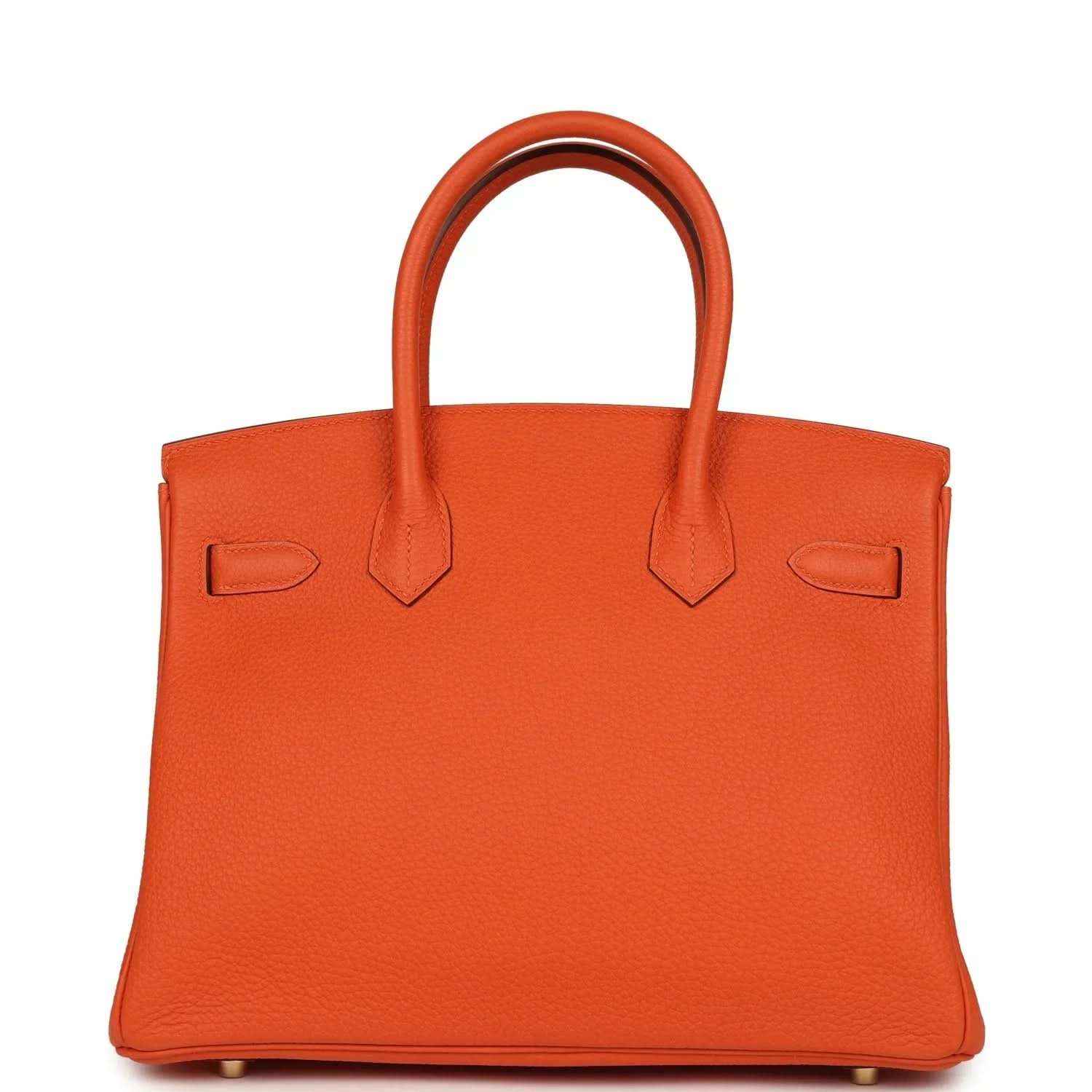 Timeless orange leather handbag with elegant top handles and sophisticated structure.