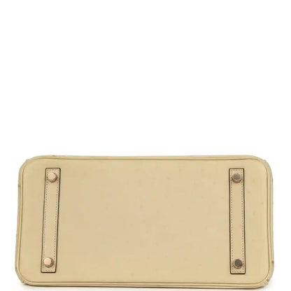 Timeless beige leather handbag base with elegant stitching and gold-tone metal feet.