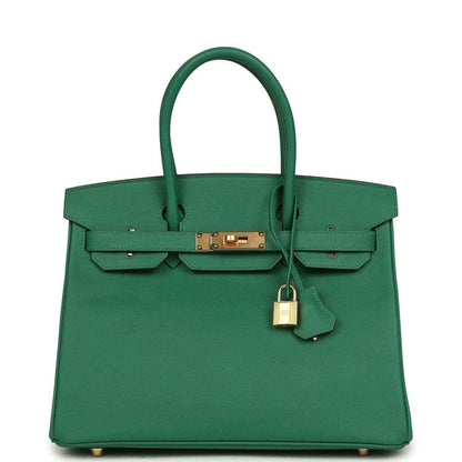 Elegant green leather handbag with gold hardware and structured, sophisticated design.