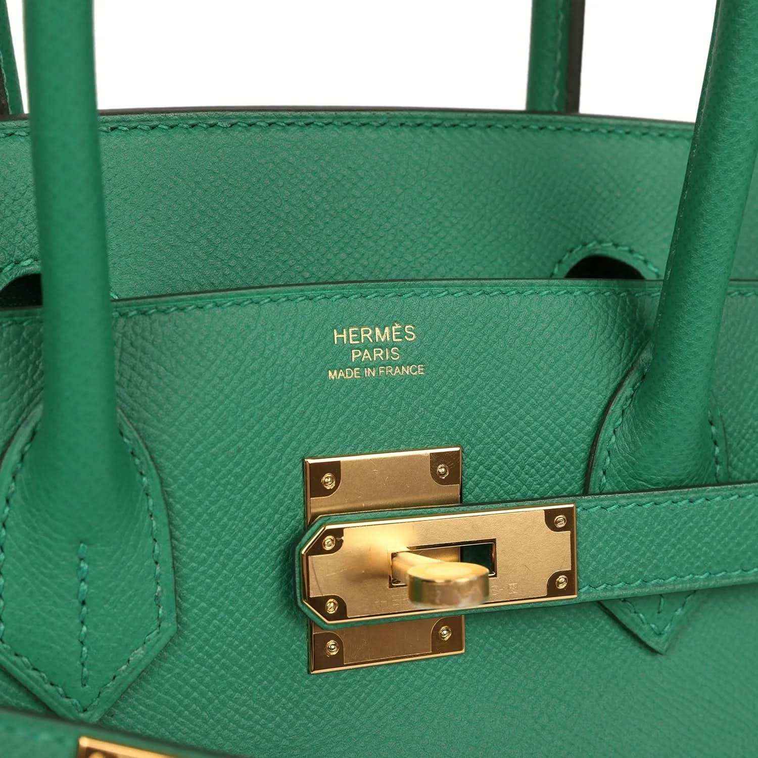 Elegant green leather handbag with gold hardware, showcasing a timeless and sophisticated style.