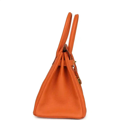 Elegant orange leather handbag with a timeless, sophisticated side profile