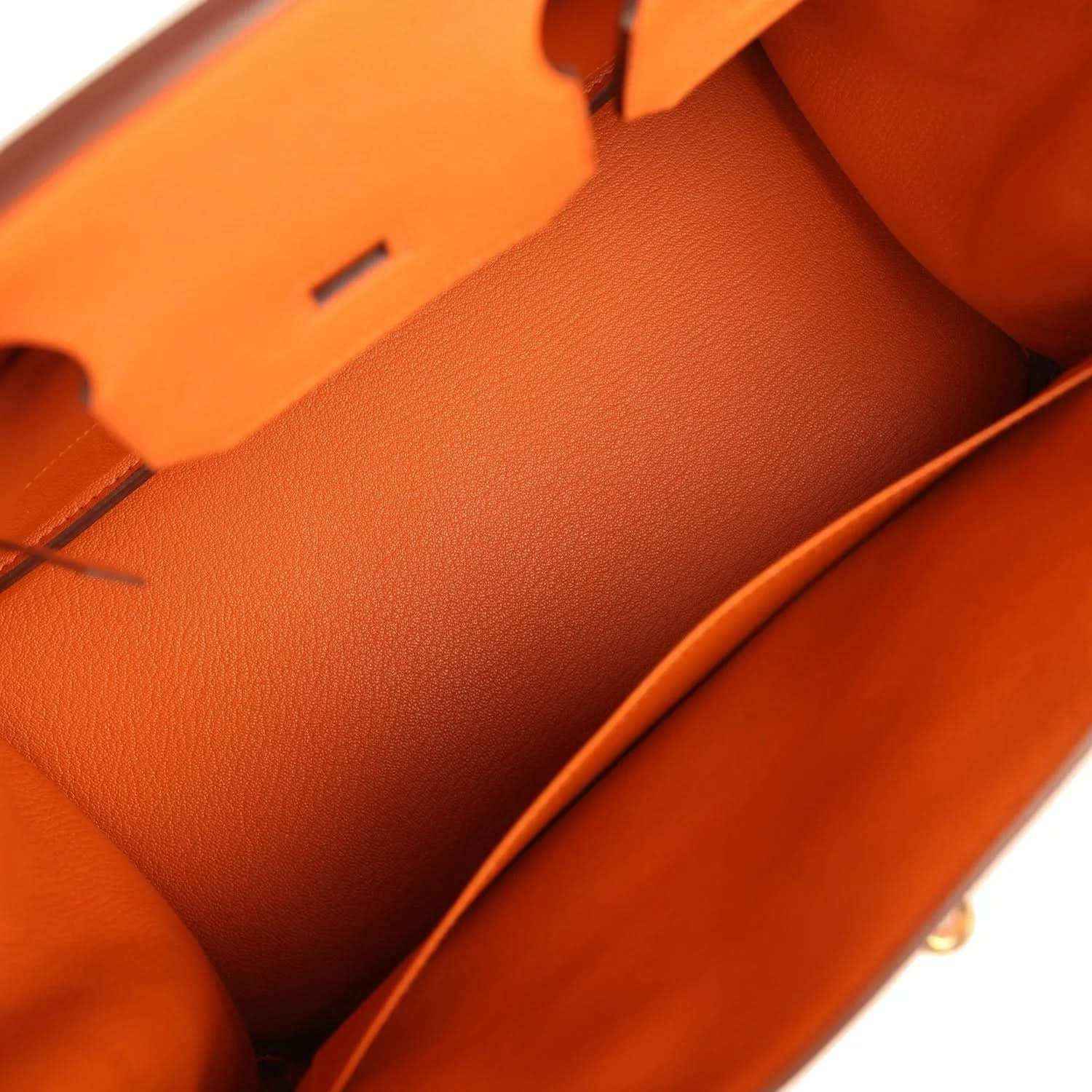 Timeless orange leather handbag interior with elegant, sophisticated design and smooth finish.