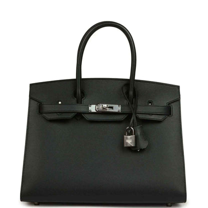 Timeless black leather handbag with elegant silver hardware and structured silhouette.