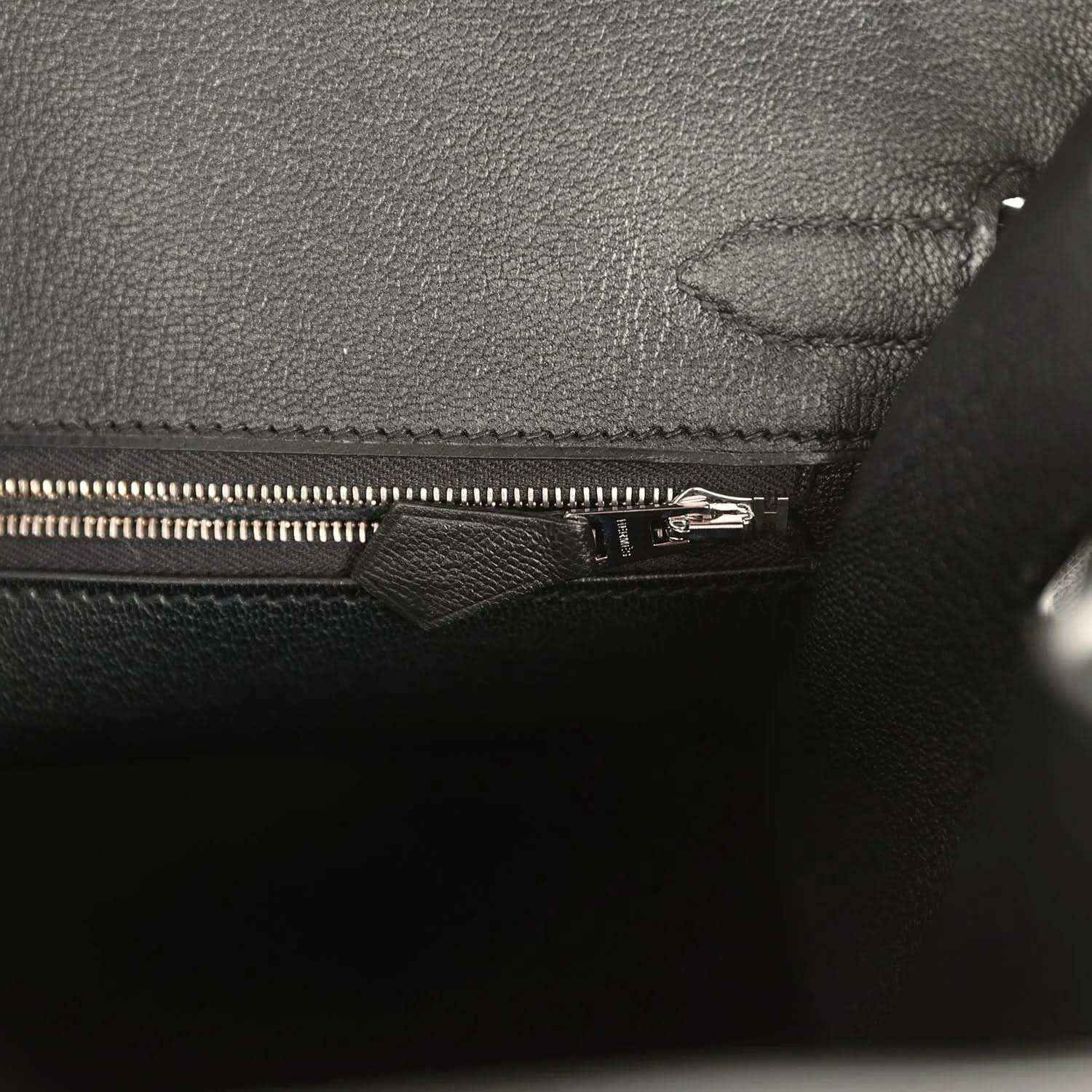 Elegant black leather handbag interior with sophisticated zipper detailing